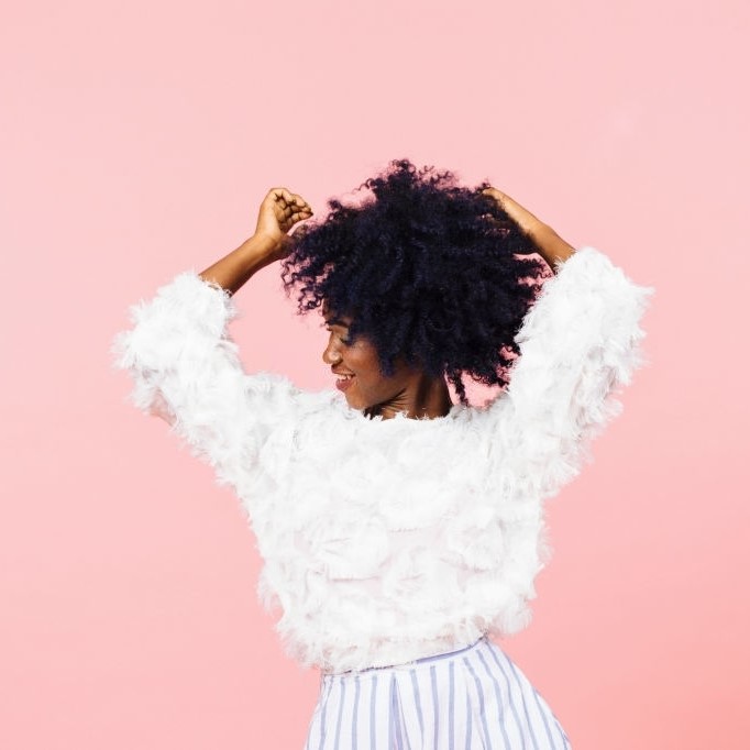Elegant woman dancing with arms up