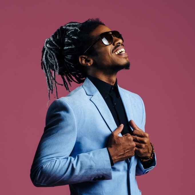 Portrait of a man with cool hair and sunglasses looking up